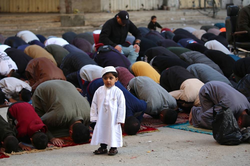 Palestinians attend Eid al-Fitr prayers, which marks the end of the holy fasting month of Ramadan, in the Nuseirat camp for Palestinian refugees in the central Gaza Strip, on Sunday. AFP