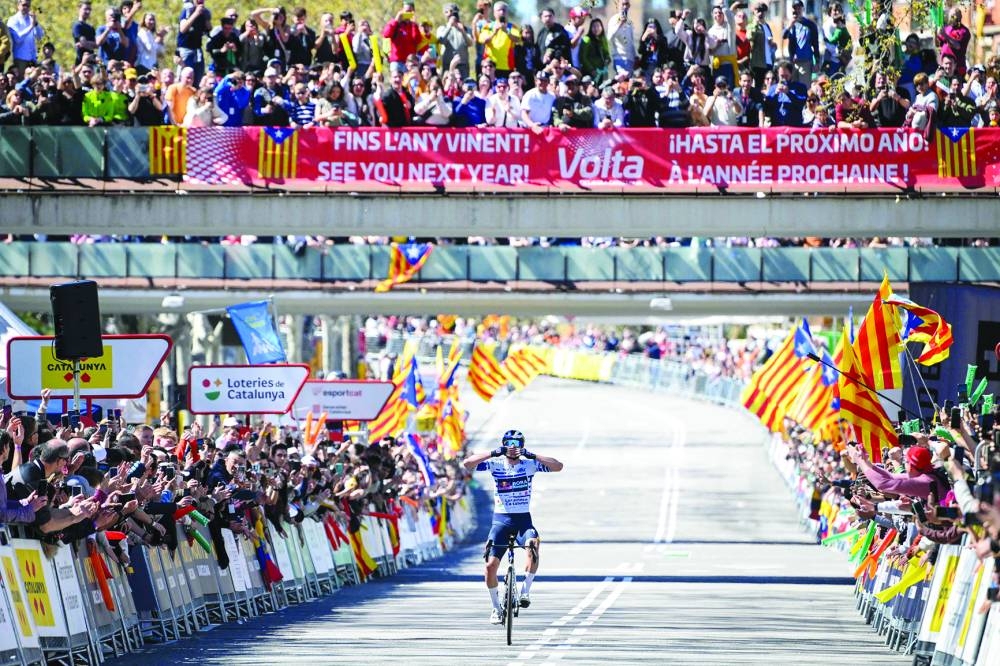 Team Bora’s Primoz Roglic (also inset) celebrates as he crosses the finish line to win the 7th and final stage of the 2025 Volta a Catalunya, a 88.2km loop between Barcelona and Barcelona, yesterday. (AFP)