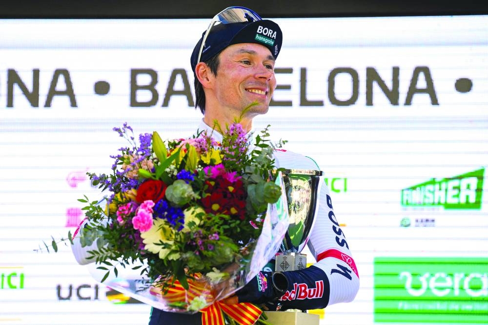 Team Bora's Primoz Roglic celebrates on the podium after winning the 2025 Volta a Catalunya cycling tour of Catalonia race, a 88,2 km loop between Barcelona and Barcelona, on March 30, 2025. Roglic won the Vuelta a Catalunya on Sunday, soloing through the seventh and final stage in Barcelona, where his main rival Juan Ayuso (UAE) fell behind in the final. Roglic, who was a second behind Ayuso at the start of this final stage, broke away with 20 km to go and managed to maintain his lead to secure his second Volta a Catalunya victory. (Photo by Josep LAGO / AFP)