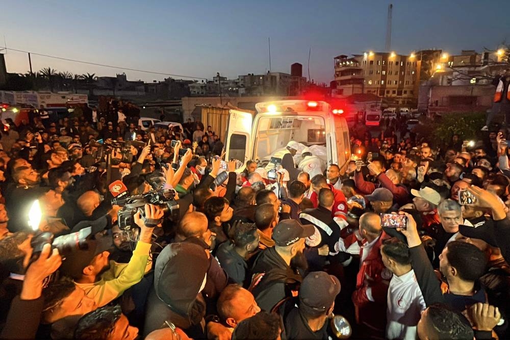 Paramedics transport out of an ambulance some of the bodies of Palestinian first responders, who were killed a week before in Israeli military fire on ambulances, into Nasser Medical Complex in Khan Yunis in the southern Gaza Strip on Sunday. AFP