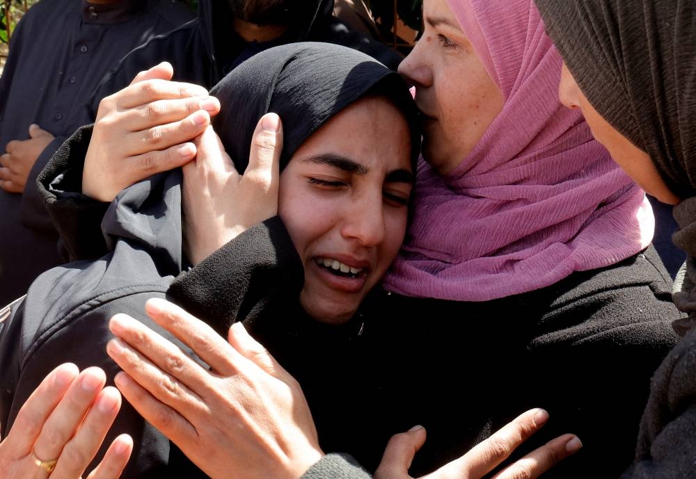 Mourners react near the bodies of Palestinians killed in Israeli strikes, at Nasser hospital, in Khan Younis, in the southern Gaza Strip on Monday. REUTERS