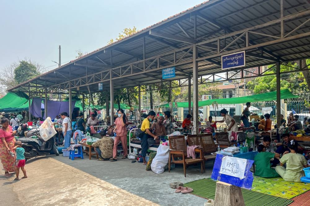 Patients lie on beds inside the compound of Mandalay General Hospital following a strong earthquake in Mandalay, Myanmar, on Tuesday. REUTERS