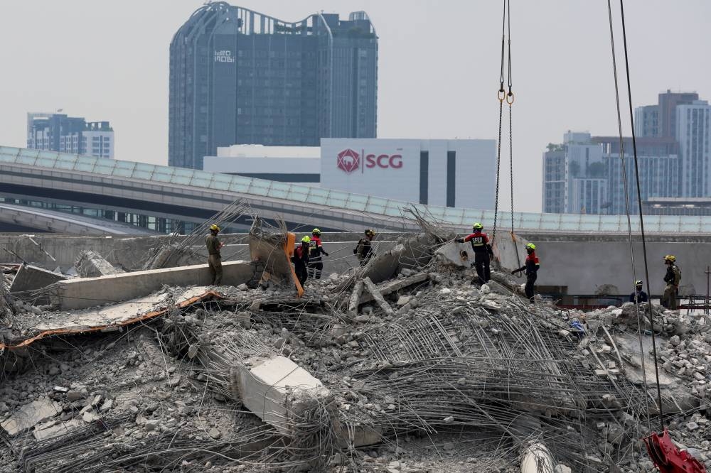 Rescue workers operate at the site of a collapsed building, following a strong earthquake, in Bangkok, on Tuesday. REUTERS