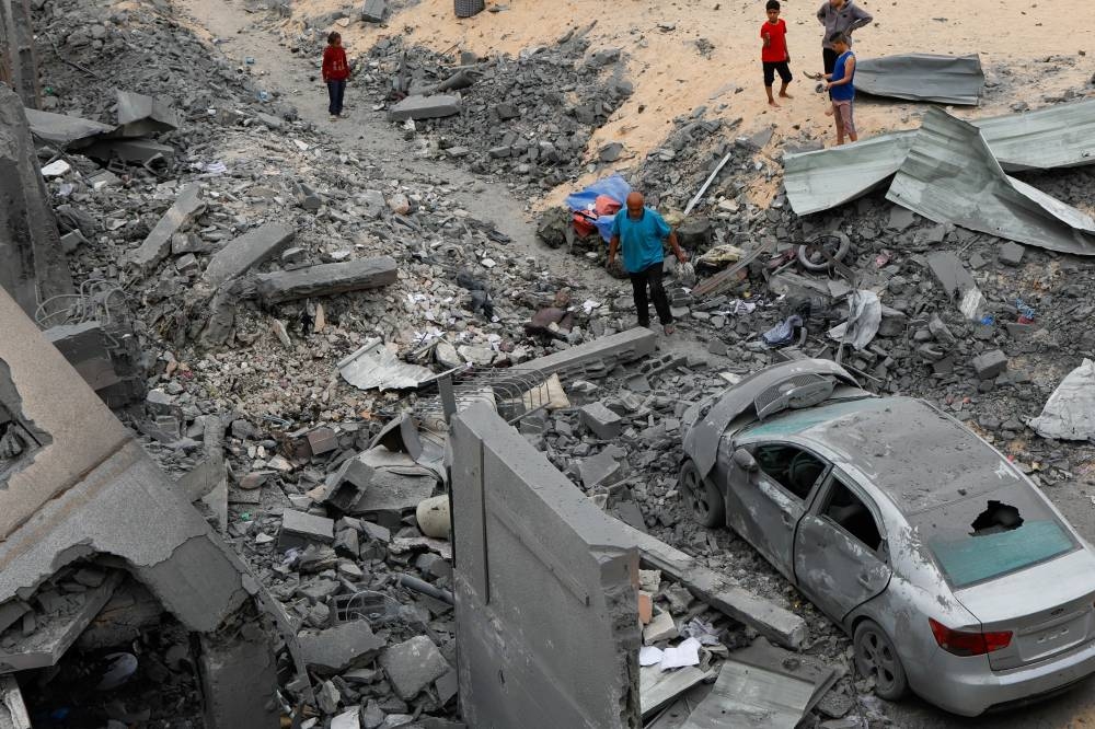 Palestinians inspect the site of an Israeli strike on a house, in Khan Younis in the southern Gaza Strip on Tuesday. REUTERS