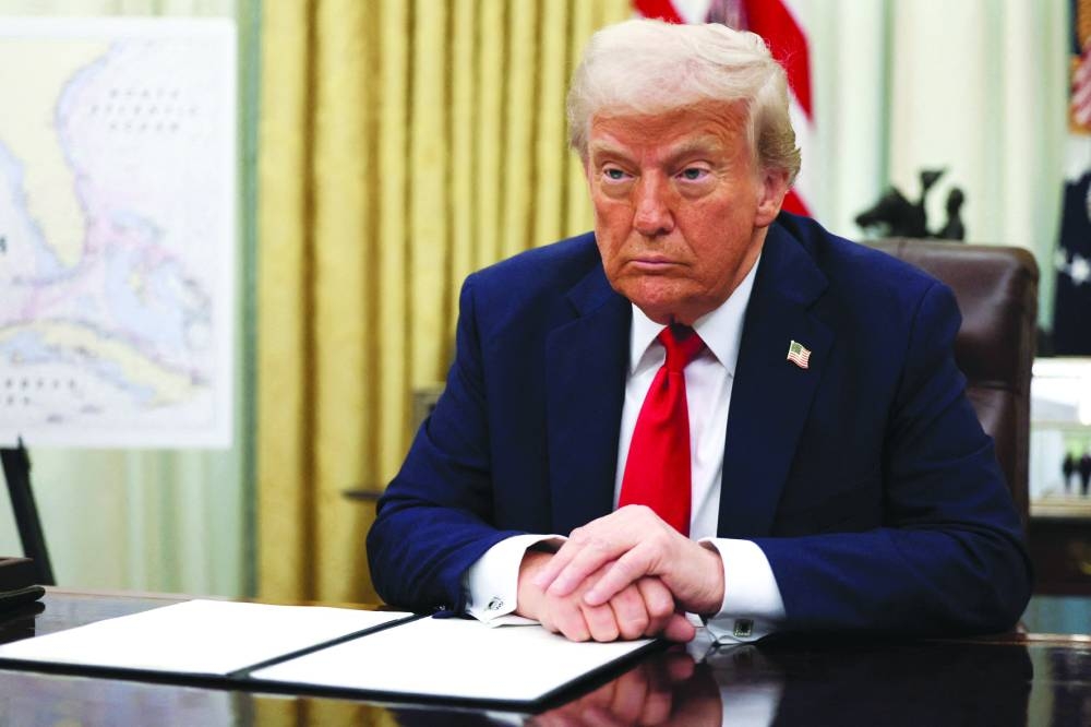 US President Donald Trump prepares to sign an executive order in the Oval Office at the White House in Washington, on Monday.