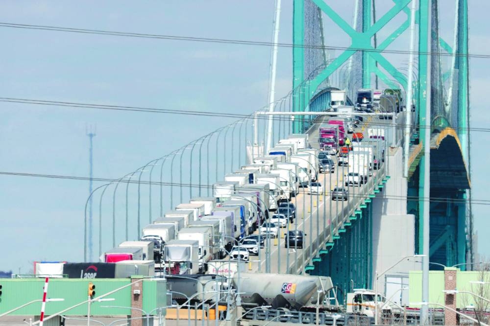 Vehicles cross the Ambassador Bridge, which carries about 25% of all trade between the US and Canada, in Windsor, Ontario, Tuesday