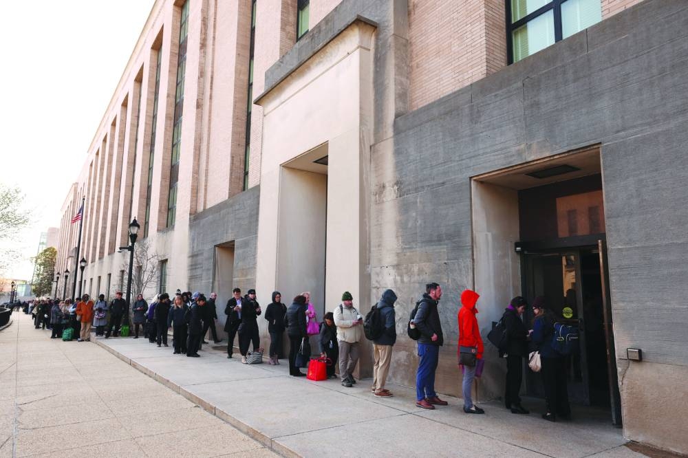 Employees of the Department of Health and Human Services queue outside the Mary E Switzer Memorial Building in Washington, DC, after it was reported that the Trump administration fired staff at the Centres for Disease Control and Prevention  and at the Food and Drug Administration, as it embarked on its plan to cut 10,000 jobs at the HHS. – Reuters