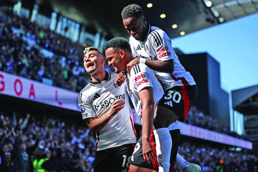 Fulham’s Rodrigo Muniz (centre) celebrates with Andreas Pereira (left) and Ryan Sessegnon after scoring against Liverpool during the English Premier League match at Craven Cottage in London on Sunday. (AFP)