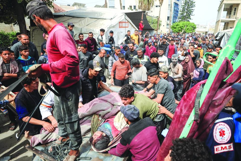 Palestinian casualties are rushed into Al-Ahli Arab Baptist Hospital, following an Israeli strike, in Gaza City on Wednesday 