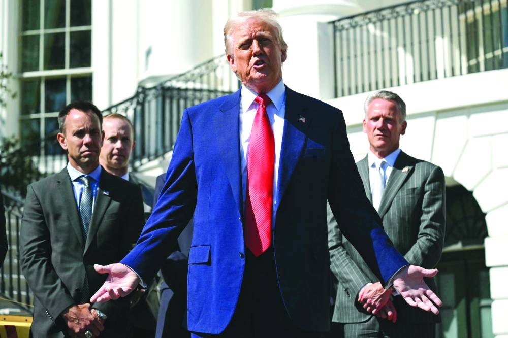 Trump speaks during a photo opportunity with autoracing officials and champions on the South Portico of the White House on Wednesday 