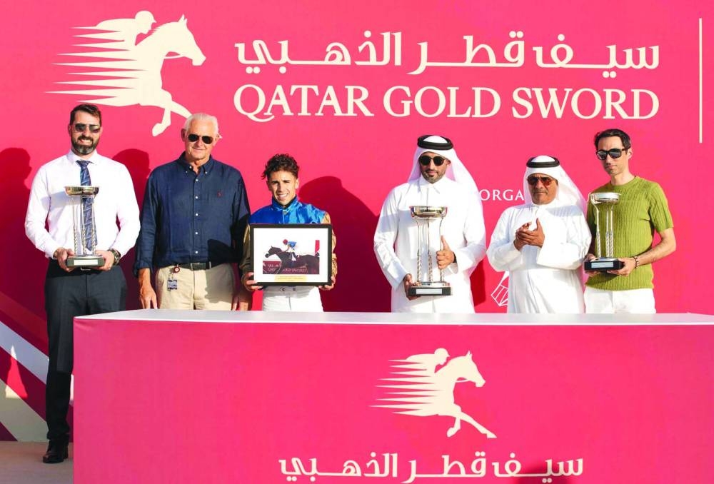 
Connections of Dark Trooper, which won the Sealine Sprint Trophy, pose with the trophies. 