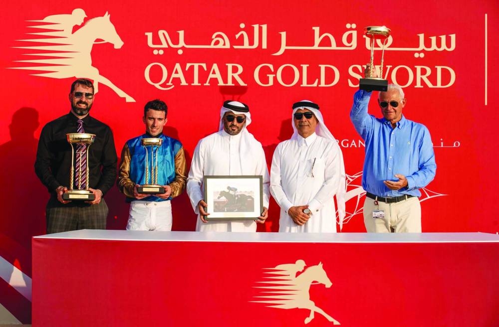 
Connections of Bolthole pose with the trophies after the horse successfully defended his title in the QA Group 1 Qatar Gold Trophy. 