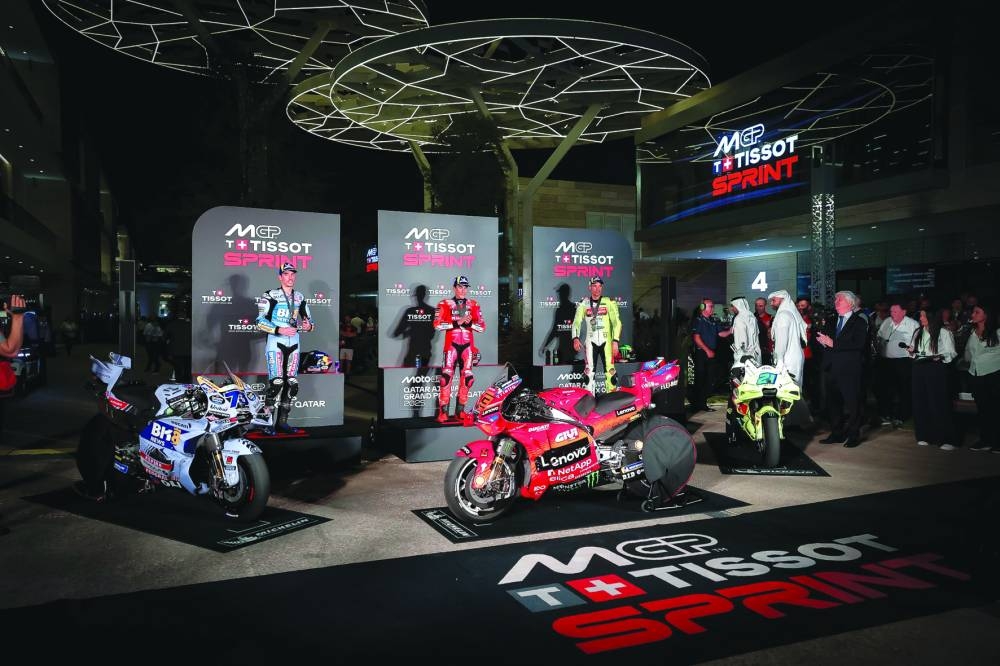 From Left: Gresini Racing’s Alex Marquez, Ducati’s Marc Marquez and VR46 Racing’s Franco Morbidelli pose for a picture following the Qatar MotoGP Grand Prix sprint race at the Lusail International Circuit on Saturday. FIM President Jorge Viegas and Lusail International Circuit CEO Abdulaziz Ali al-Mohannadi honoured the podium winners.
