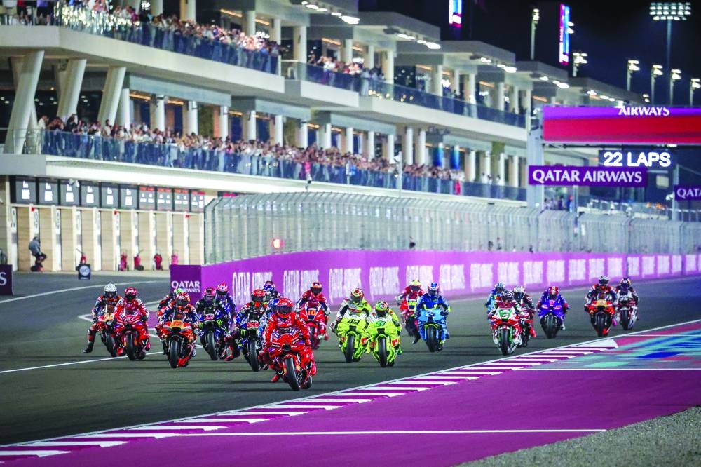 Riders jostle for position as the lights go out at the Qatar MotoGP Grand Prix at Lusail International Circuit.