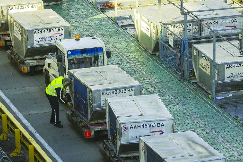 
A cargo handler prepares air freight containers for a British Airways flight at Heathrow Airport in London. Air cargo has always played a key role in maintaining global supply chain resilience. On an average day, 180,000 tonnes of goods reach their destination by air, according to the International Air Transport Association. 