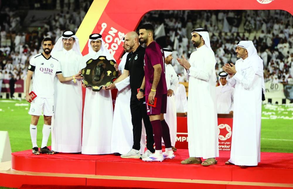 
Jassim bin Rashid al-Buenain, President of Qatar Football Association and Qatar Stars League and Hani Taleb Ballan, CEO of QSL, crowned Al Sadd as champions in the presence of engineer Abdullah bin Hamad al-Attiyah, Vice-President of Al Sadd club; Sheikh Khalifa bin Khalid al-Thani, Board Member of Al Sadd club; and Sheikh Ali bin Jabor al-Thani, CEO of Ooredoo Qatar. 