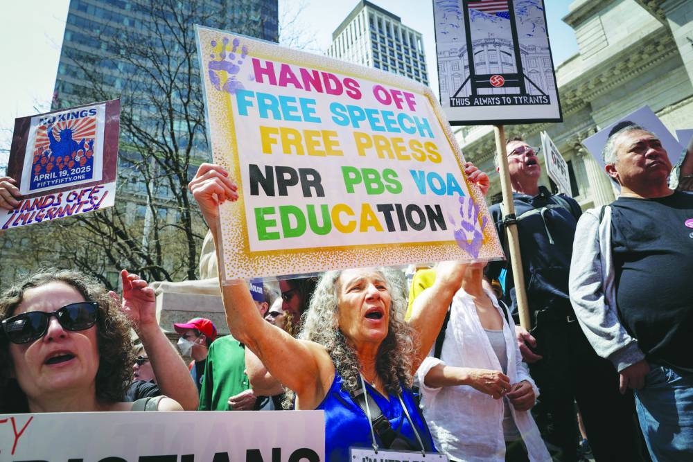 People hold up signs as they demonstrate during a rally titled ‘Protect Migrants, Protect the Planet’, in New York City yesterday. The group called on New York City to stop collaborating with the Immigration and Customs Enforcement (ICE) agency, protect immigrant communities, and end the targeting of student protesters. – AFP