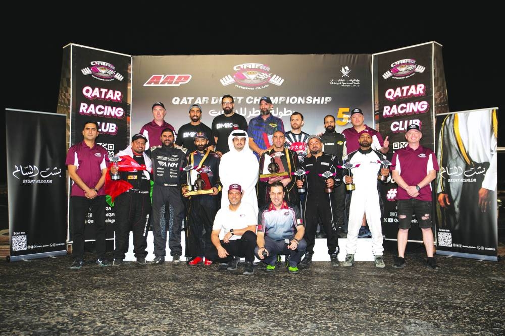 
QRC Director General Sheikh Jabor bin Khalid al-Thani poses with the winners of the Qatar Drift Championship.
 