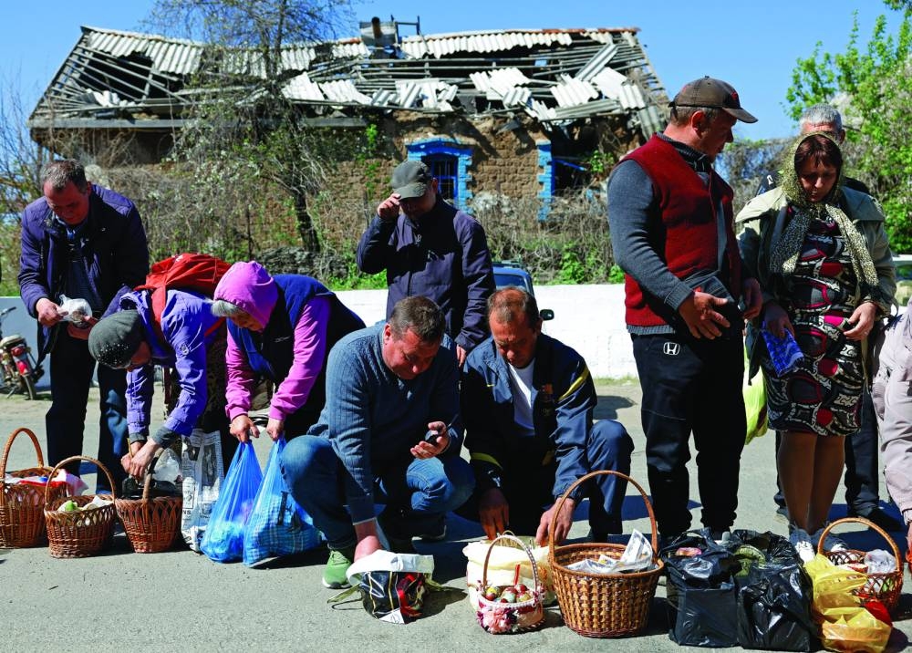 People prepare traditional Easter cakes and eggs in the Donetsk region, a Russian-controlled area of Ukraine, on Sunday. (Reuters)