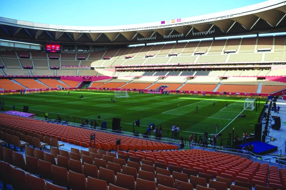 Grounds crew mow the grass after Real Madrid failed to attend a training session at La Cartuja stadium in Seville on Friday, on the eve of their Copa del Rey final against Barcelona (AFP)