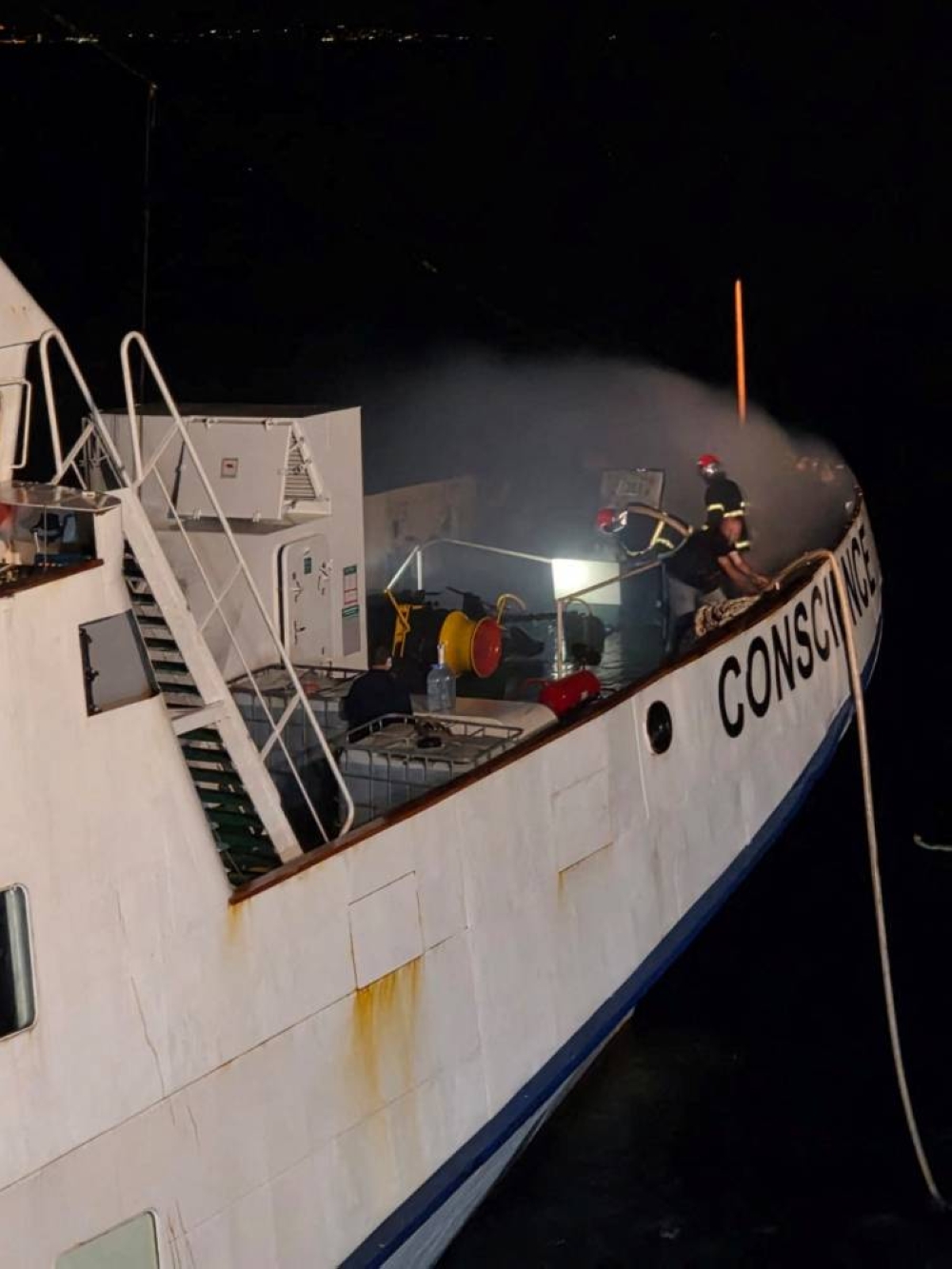 Firefighters try to extinguish a fire onboard the Gaza Freedom Flotilla vessel Conscience, as seen from the tug vessel EDT Aeolus, off Malta, on Friday.  EDT Offshore/Handout via REUTERS