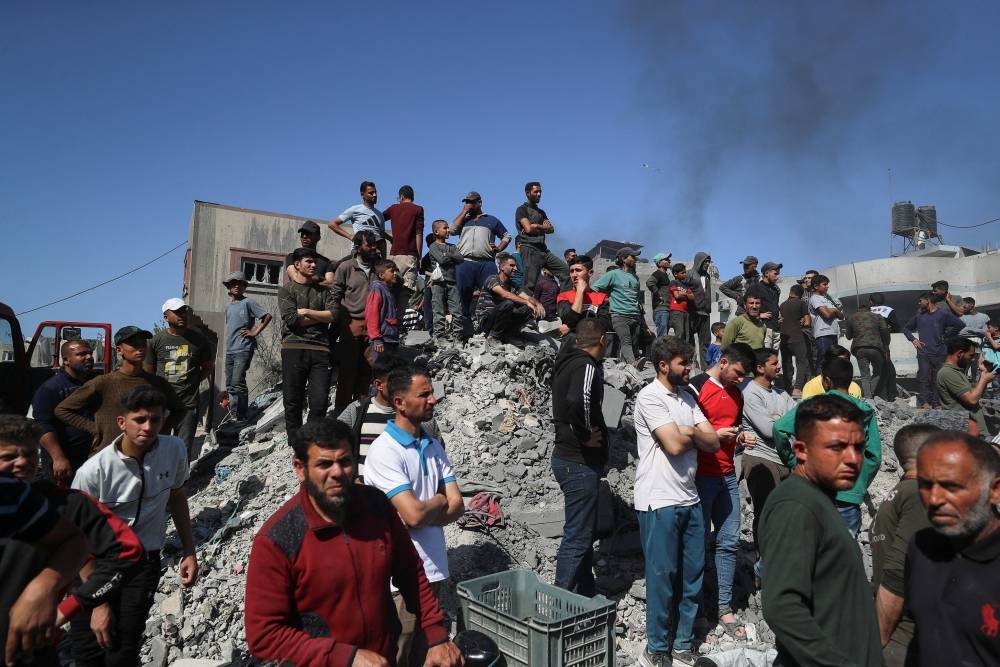 Palestinians inspect the site of an Israeli strike on a house in Jabalia in the northern Gaza Strip on Friday. REUTERS