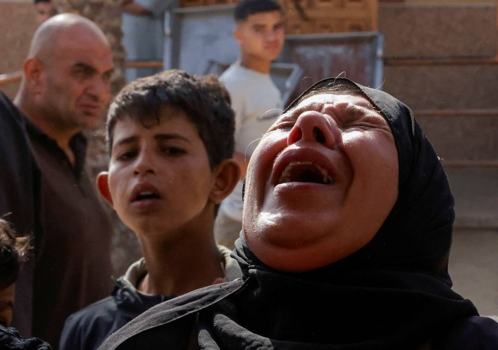 A woman reacts as she attends the funeral of Palestinians killed in Israeli strikes, in Khan Younis, southern Gaza Strip, on Saturday. REUTERS