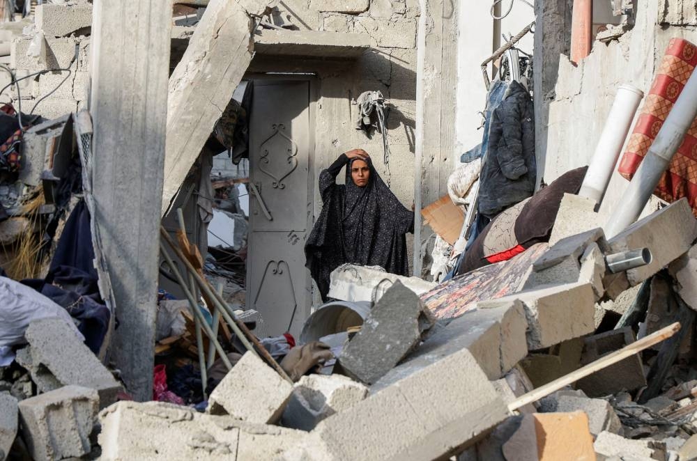 A Palestinian inspects the site of an Israeli strike on a house, in Khan Younis in the southern Gaza Strip, on Saturday. REUTERS