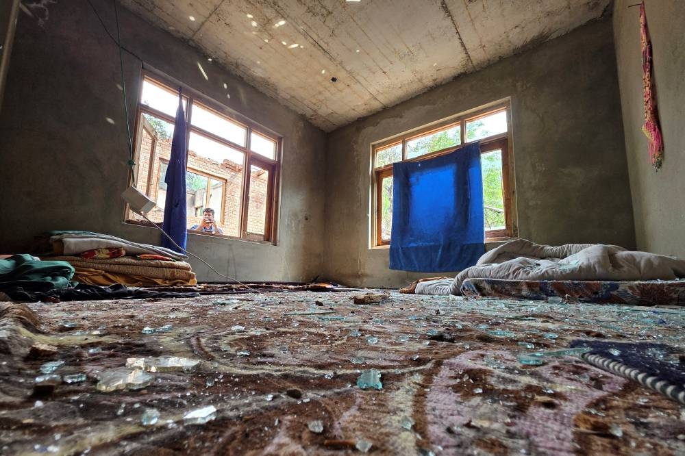 Broken glass pieces are seen on a carpet inside a residential house after it was partailly damaged by a cross-border shelling in Salamabad in India-administered Kashmir's Baramulla district, on Wednesday. REUTERS