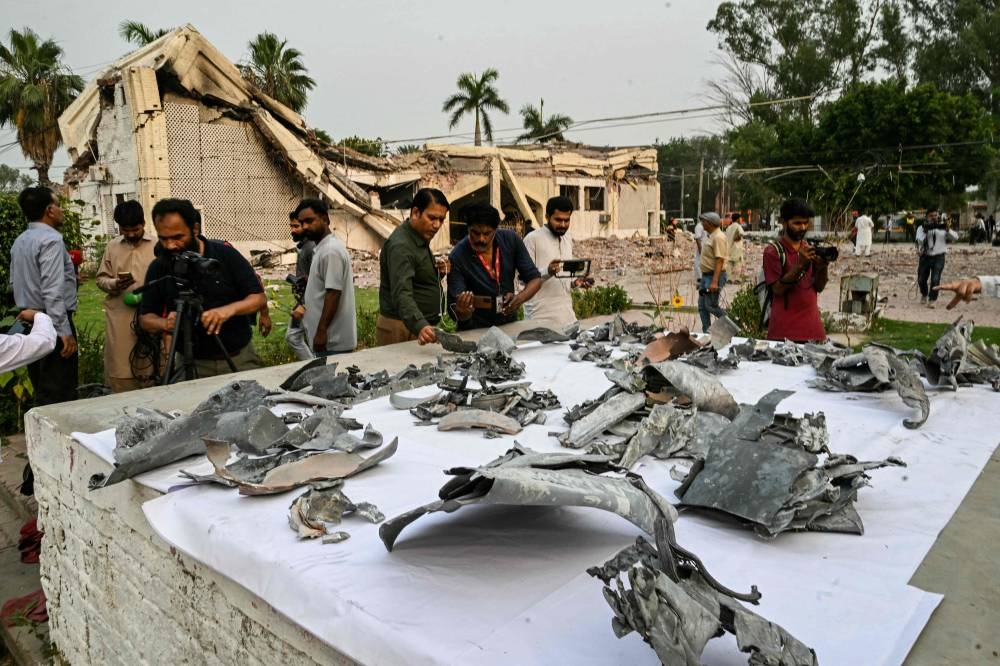 Journalists look at wreckage of missiles at the Government Health and Educational complex in Muridke about 30 kilometres from Lahore, on Wednesday, after Indian strikes. AFP