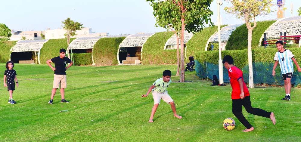 
Children playing football at the Umm Al Seneem Park. 