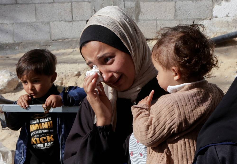 A woman reacts as she attends the funeral of Palestinians killed in Israeli strikes, in Khan Younis, southern Gaza Strip, yesterday.