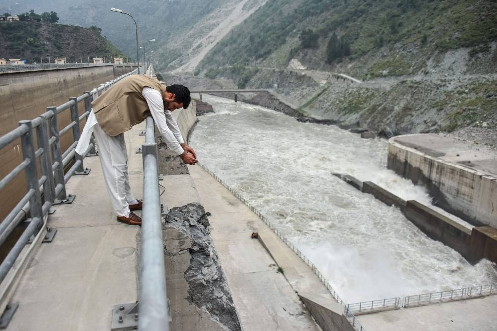 A journalist takes photographs of the damaged wall of the Neelum Jhelum Hydropower Project is pictured following Indian strikes in Nausari, about 40kms from Muzaffarabad, the capital of Pakistan-administered Kashmir, on Thursday. AFP