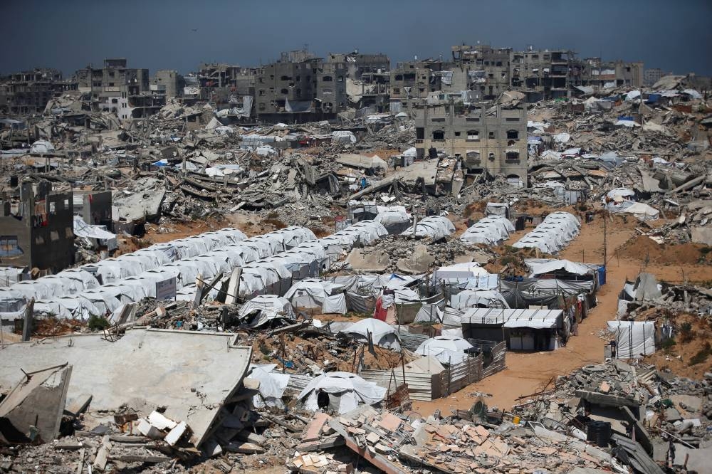 Palestinians displaced by the Israeli military offensive, shelter in tents near the rubble of houses in Jabalia refugee camp, in the northern Gaza Strip. REUTERS