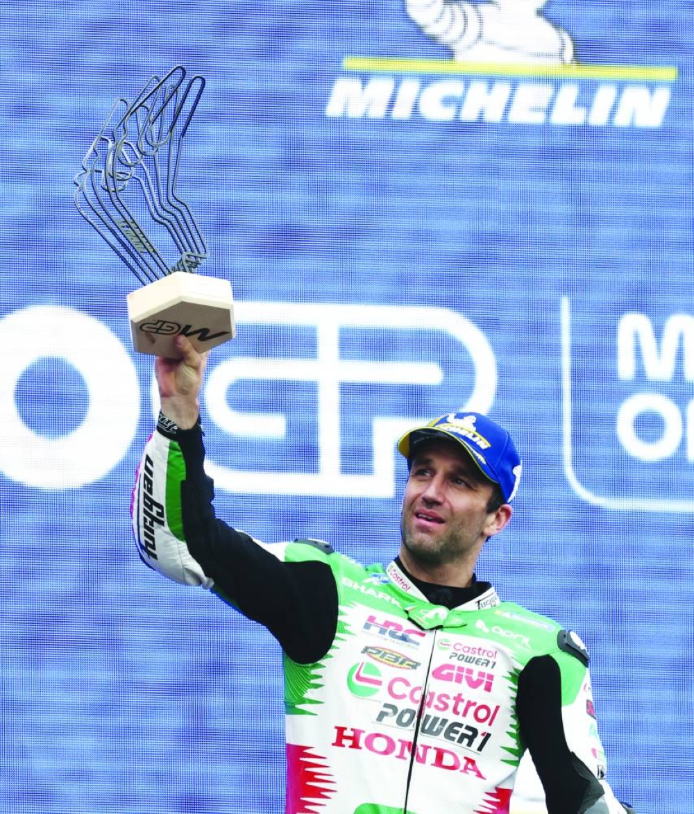 MotoGP - French Grand Prix - Bugatti Circuit, Le Mans, France - May 11, 2025 LCR Honda's Johann Zarco celebrates with his trophy on the podium after winning the MotoGP race REUTERS/Stephane Mahe