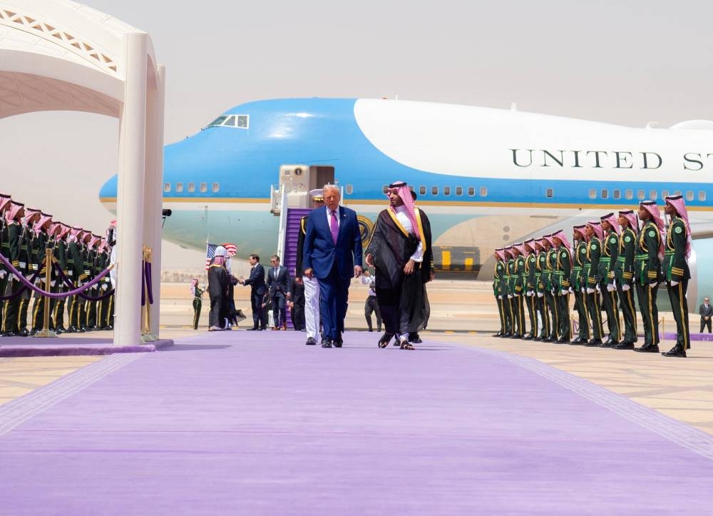 US President Donald Trump walks with Saudi Crown Prince Mohammed Bin Salman during a welcoming ceremony in Riyadh, Saudi Arabia, Tuesday. Bandar Algaloud/Courtesy of Saudi Royal Court/Handout via REUTERS