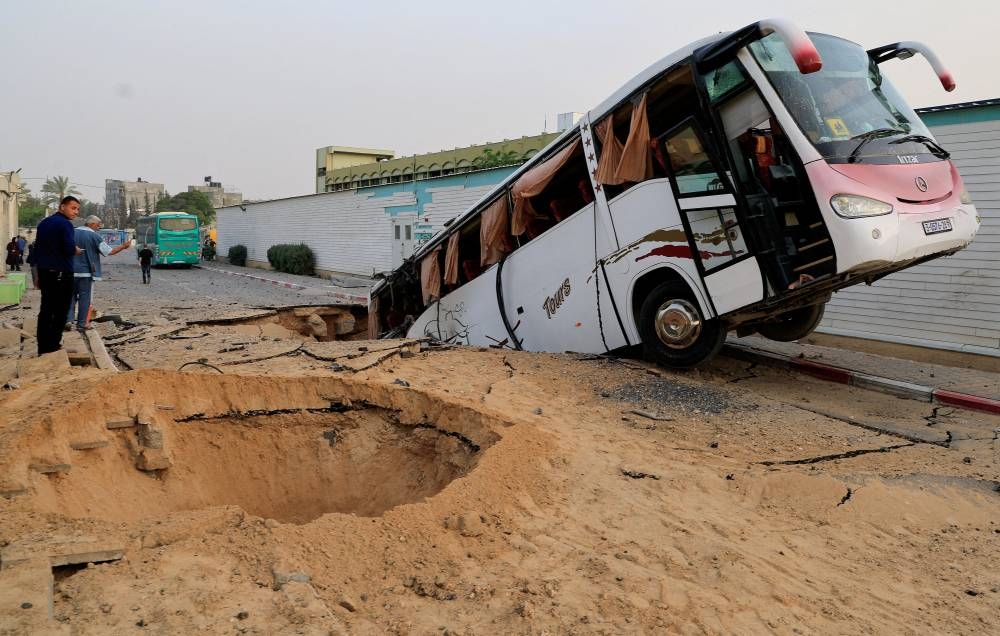 Palestinians inspect the damage, after the European Hospital was partially damaged in Israeli airstrikes, according to the Gaza Health Ministry, in Khan Younis, in the southern Gaza Strip, on Tuesday. REUTERS