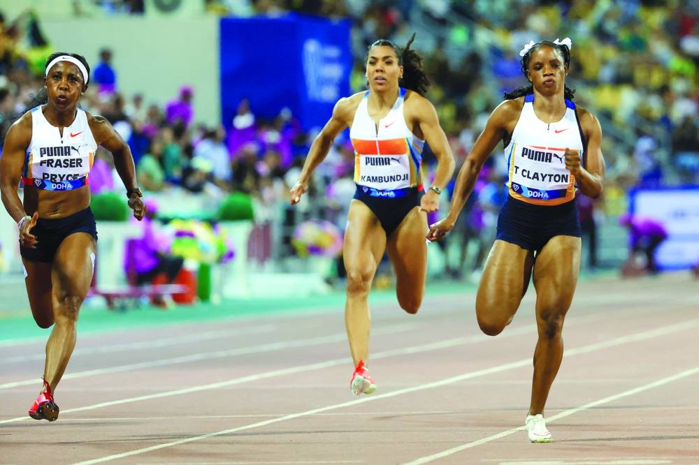 
Jamaica’s Shelly-Ann Fraser-Pryce (left) and Tia Clayton compete in the women’s 100m during the Doha Diamond League. (AFP)  