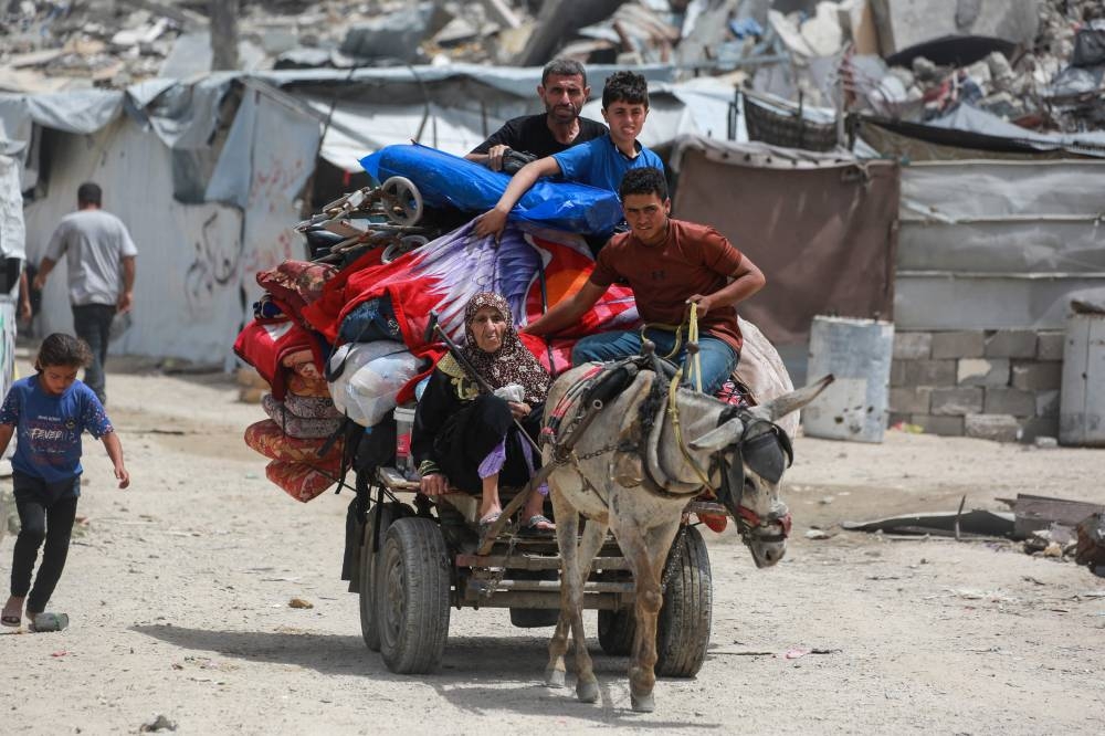 Palestinians move with their belongings as they flee the northern cities of Jabalia and Beit Lahia Gaza Strip towards Gaza City amid continuous Israeli strikes in the besieged Palestinian territory, on Saturday. AFP