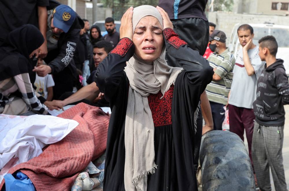 A woman reacts during the funeral of Palestinians killed in Israeli strikes, at Al-Aqsa Martyrs hospital, in Deir Al-Balah in the central Gaza Strip, on Sunday. REUTERS