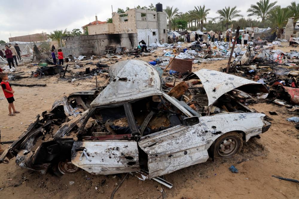 Palestinians inspect the damage at the site of an Israeli strike on a tent camp sheltering displaced people, in Khan Younis, southern Gaza Strip, on Sunday. REUTERS