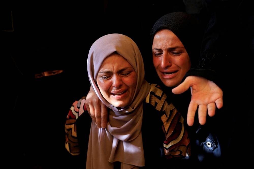 Mourners attend the funeral of Palestinians killed in Israeli strikes, at Nasser hospital, in Khan Younis, southern Gaza Strip, on Sunday. REUTERS