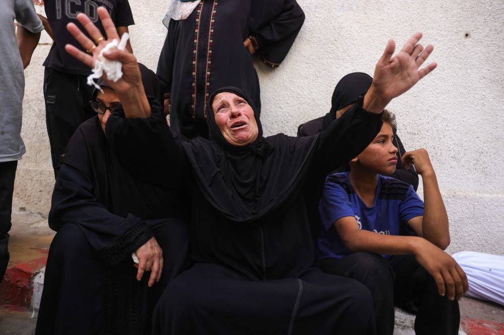 Palestinians mourn relatives killed in Israeli strikes, at Al-Shifa hospital in Gaza City, on Sunday. AFP