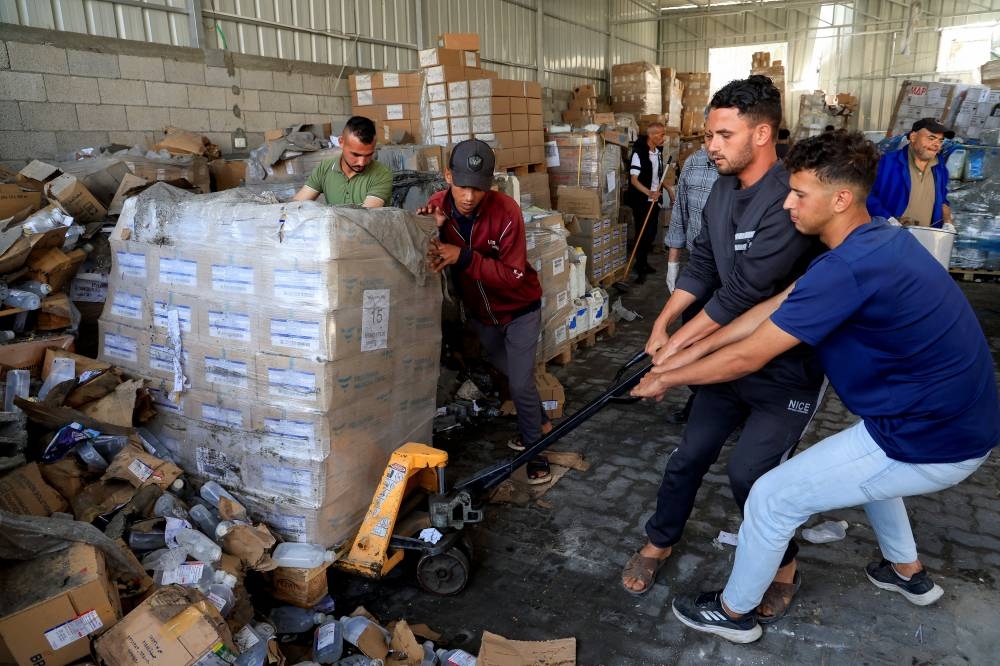 Palestinian staff members inspect the medicine warehouse in Nasser Hospital after an Israeli strike, according to the Gaza Health Ministry, in Khan Younis, southern Gaza Strip, Monday. REUTERS