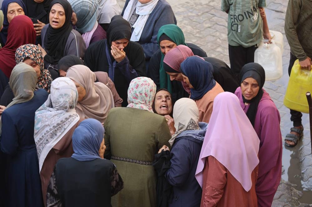 Palestinian women bid farewell to loved ones at Gaza City's Al-Ahli Arab hospital, also known as the Baptist hospital, following an  Israeli airstrike that hit an UNRWA school, serving as a shelter for people who left their homes in the besieged Palestinian territory, on Tuesday. AFP