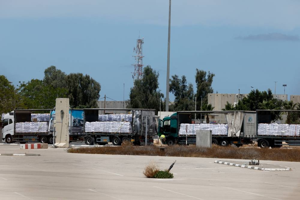 Trucks carrying aid are seen at the Kerem Shalom crossing between Israel and Gaza, on the Israeli side, on Tuesday. REUTERS