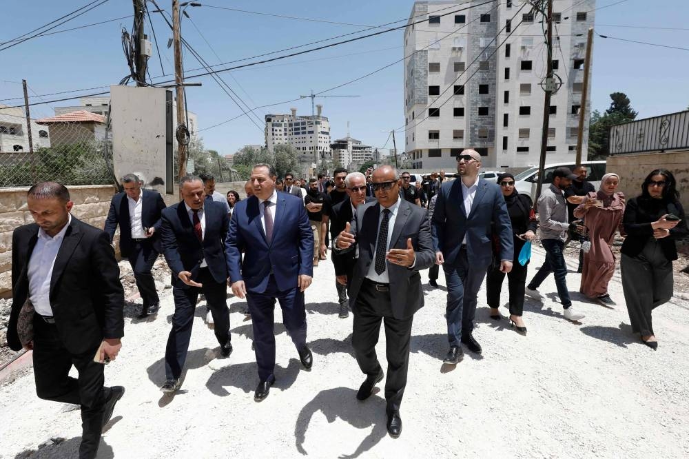 Members of a diplomatic delegation from the European Union walk near the eastern entrance of Jenin camp during a visit to the city of Jenin, on Wednesday, amid an ongoing Israeli military offensive in the occupied West Bank. AFP