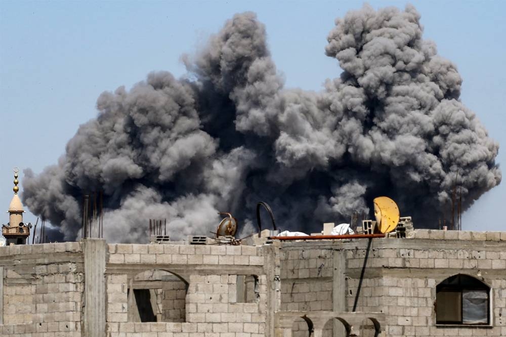 A cloud of smoke erupts from Israeli bombardment in the Bureij camp for Palestinian refugees in the central Gaza Strip on Friday. AFP