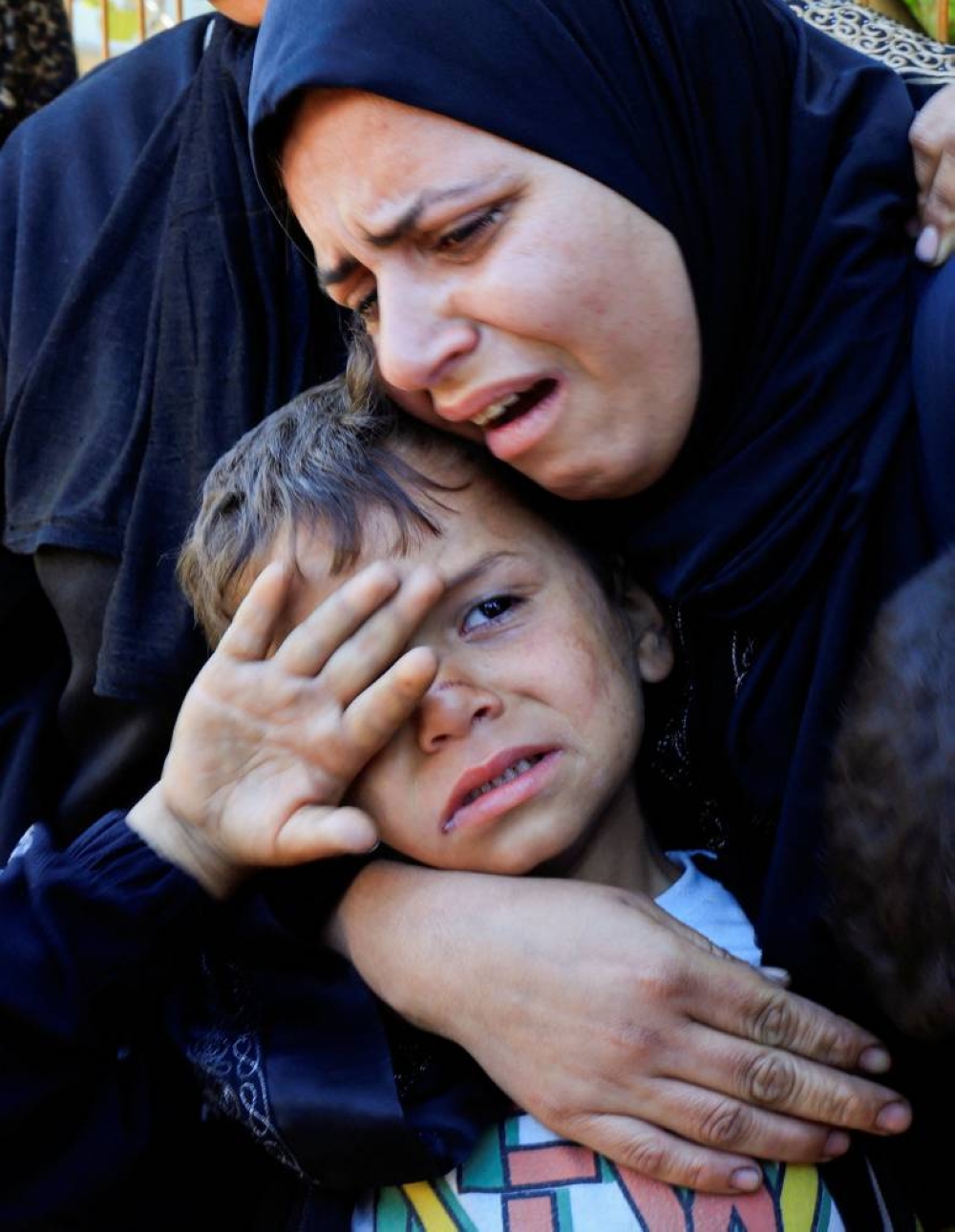 Mourners react as they attend the funeral of Palestinians killed in Israeli strikes, at Nasser hospital, in Khan Younis, in the southern Gaza Strip, on Friday. REUTERS