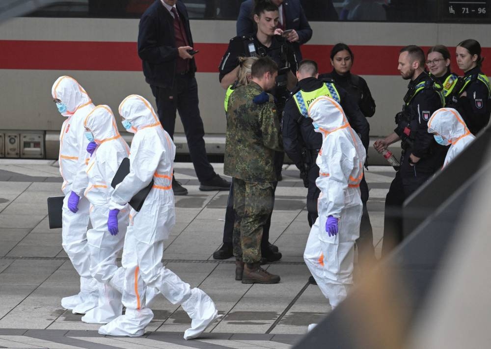 Police officers and forensic experts work at Hamburg's main train station, after several people were injured in a knife attack, in Hamburg, Germany, Friday. REUTERS
